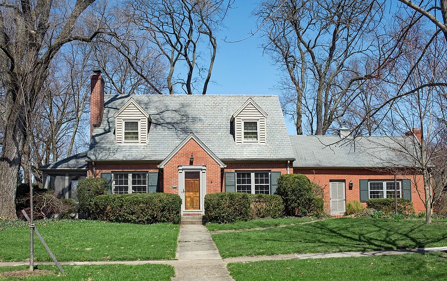 Cape cod style home in need of a new roof.